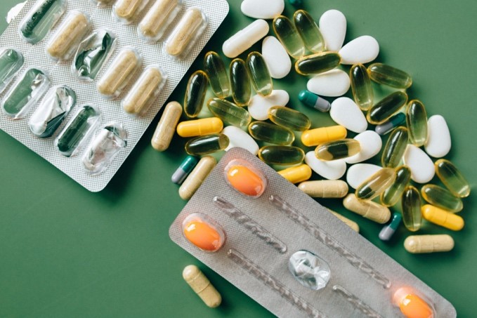 IMAGE 2: Photograph of various tablet packets and tablets, depicting medication. 